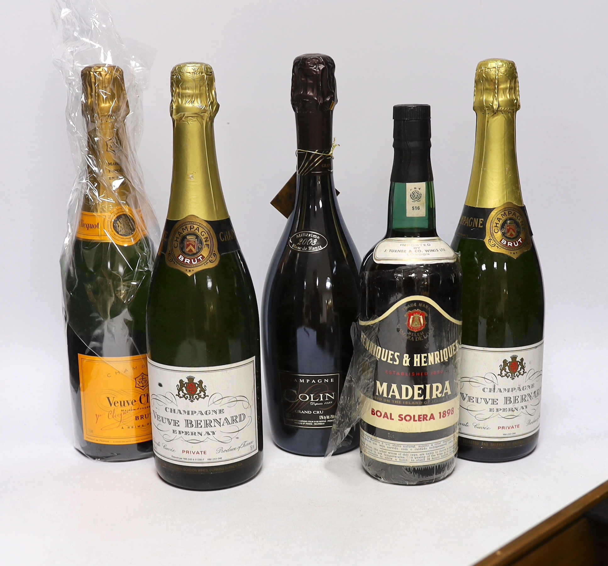 A bottle of Champagne Colin grand cru, Veuve Clienquot, two bottles of Champagne Veuve Bernard, a bottle of Madeira “Boal Solera 1898”, two small bottles cased of Two Ages of Otima, 10year old and 20 year old